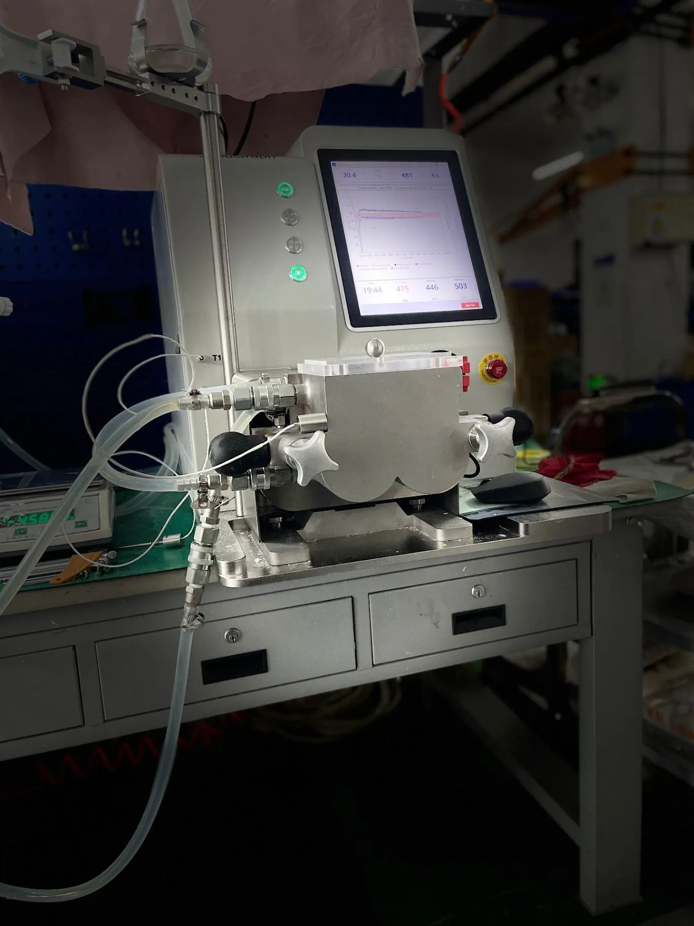 JenoGraph machine photographed from the front-left, with the touchscreen and connected tubing visible.